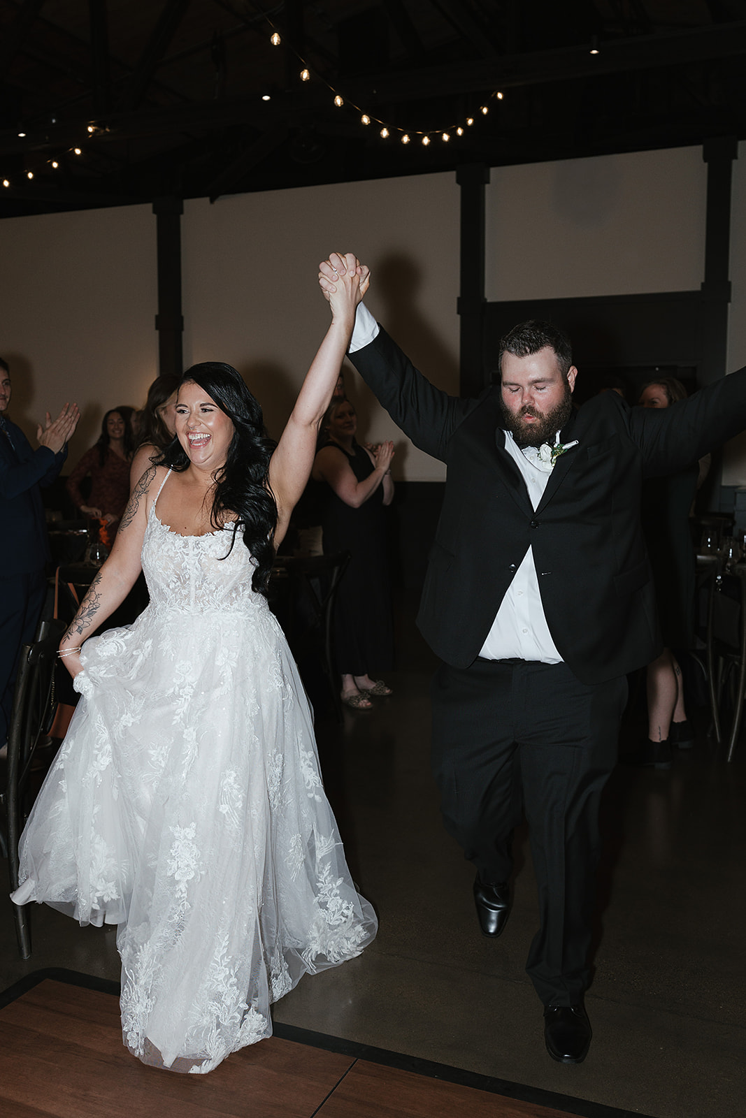 Couple celebrating grand wedding reception entrance