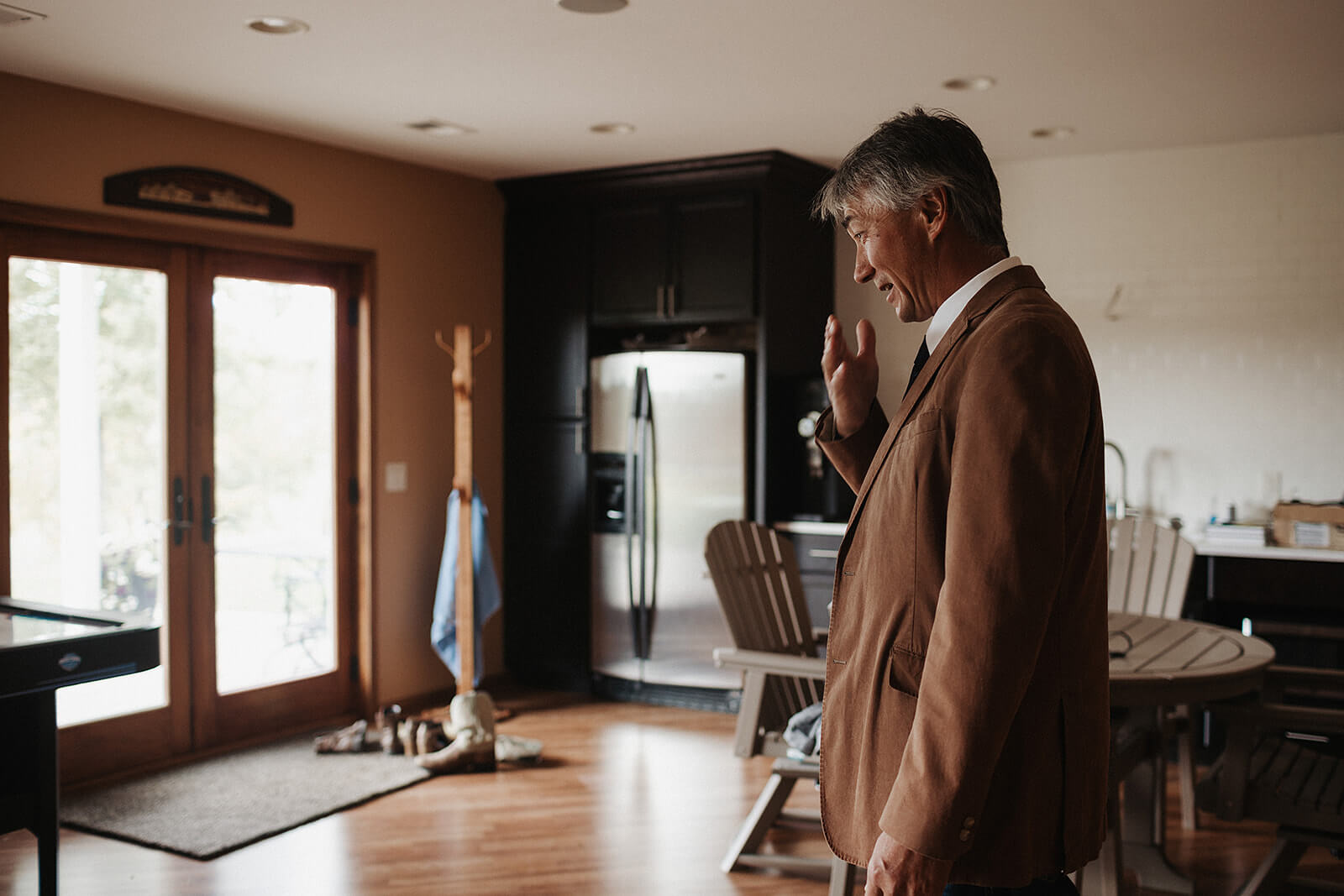 Father of the bride wiping away tears after seeing his daughter in her wedding dress for the first time at their Lancaster Wisconsin family farm